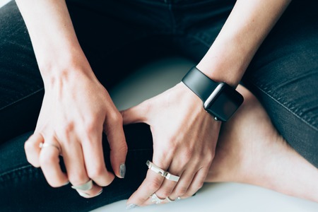 Slender girl with a smart clock on her arm
