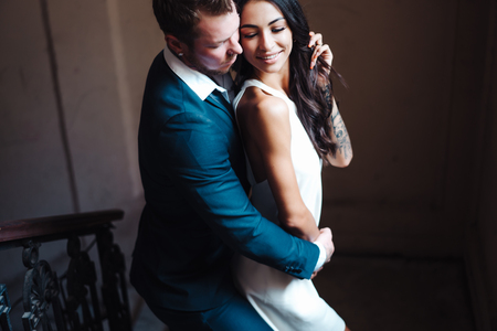 Beautiful, young couple posing on camera indoorsの写真素材