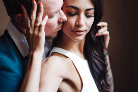 Beautiful, young couple posing on camera indoorsの写真素材