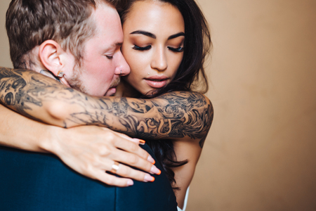 Beautiful, young couple posing on camera indoorsの写真素材