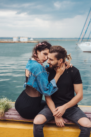 Guy and girl on pierの写真素材