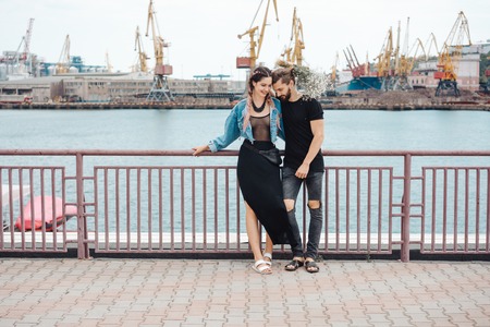 Guy and girl on pierの写真素材