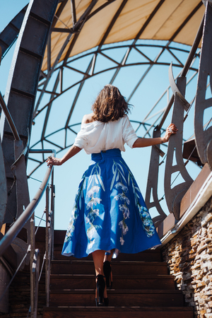 Young girl in a dress posing on a streetの写真素材
