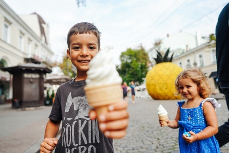 happy child eating ice cream on a summer dayの写真素材