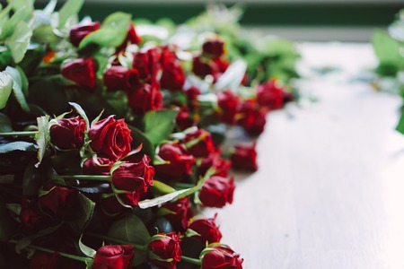 fresh cut red roses lie on the tableの写真素材