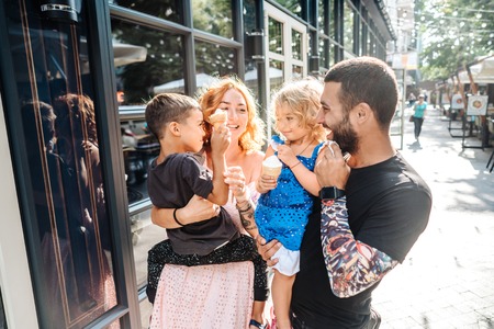 Beautiful young family with ice creamの写真素材