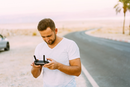 Guy controls drone with remote control