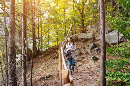 The girl walks along in the woods