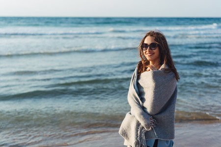 Young beautiful girl posing by the sea
