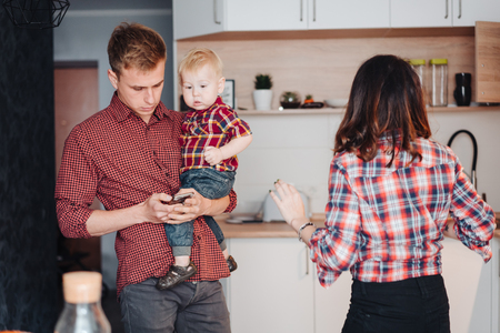 Dad, mom and little son in the kitchenの写真素材