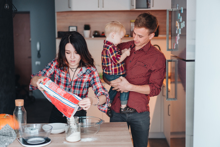 Dad, mom and little son cook a pieの写真素材