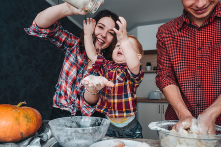 Dad, mom and little son cook a pieの写真素材