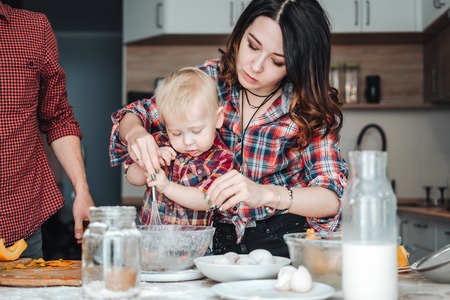 Mom and little son in the kitchenの写真素材