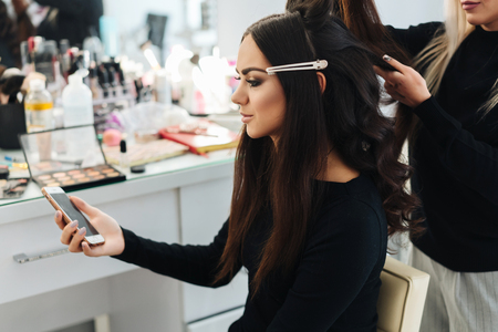 Makeup and hairstyle for a beautiful modelの写真素材