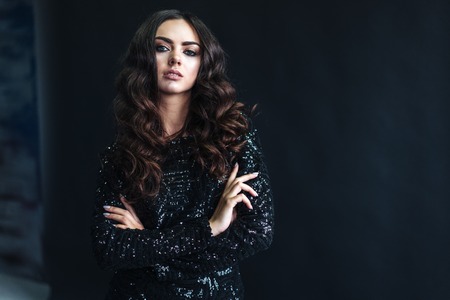 beautiful young woman with long curly hairの写真素材