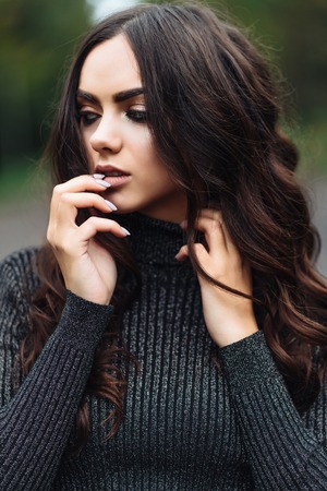 Outdoor portrait of young pretty beautiful calm womanの写真素材