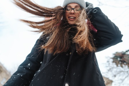 Young beautiful woman at winter cityの写真素材