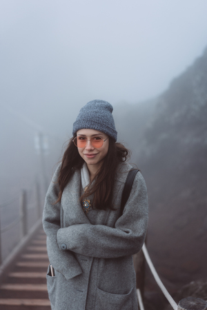 Girl climbs the path to the mountainの写真素材