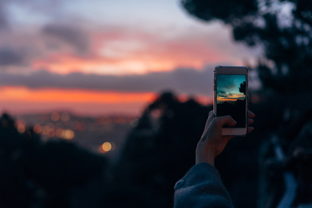 Young woman taking photoの写真素材