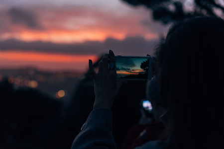 Young woman taking photoの写真素材