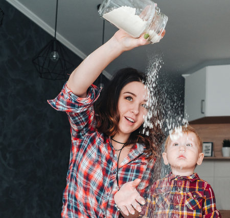 Mom and little son in the kitchenの写真素材
