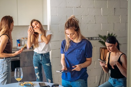 cute, young girl doing makeupの写真素材