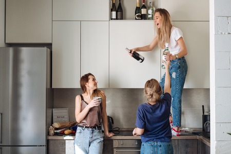 three women with bottles of alcoholの写真素材