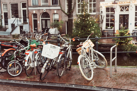 Bicycles lining a bridge over the canals of Amsterdamの写真素材
