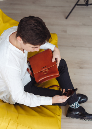 handsome guy with leather bagの写真素材