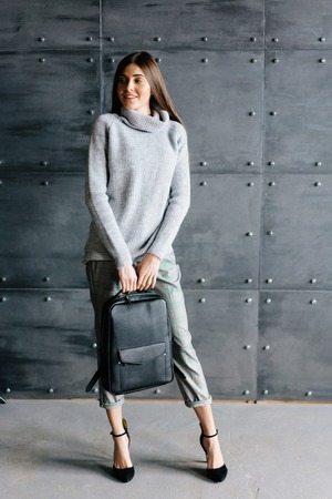 Fashionable woman hold black bagの写真素材
