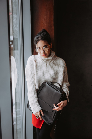 Fashionable woman hold black bagの写真素材
