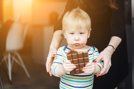 Portrait of an littel boy eating chocolateの写真素材