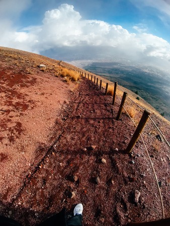 A mountain path bordered by red cliffsの写真素材