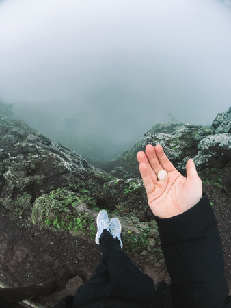 Man on cliff look at the fogの写真素材