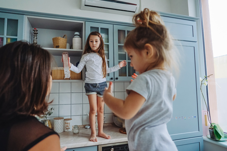 Happy family having fun in the kitchenの写真素材