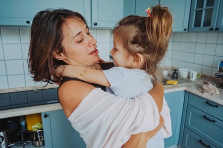 Mom and little daughter having fun togetherの写真素材