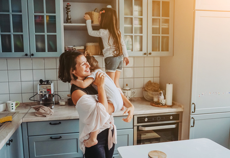 Happy family having fun in the kitchenの写真素材