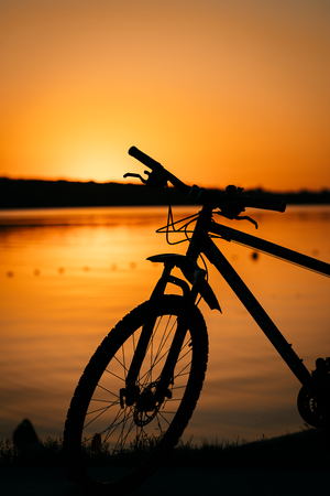 bicycle on the background of a sunsetの写真素材