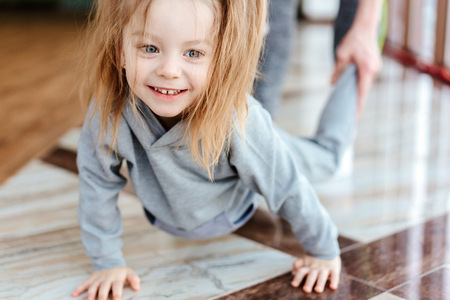 Little girl crawls on her handsの写真素材