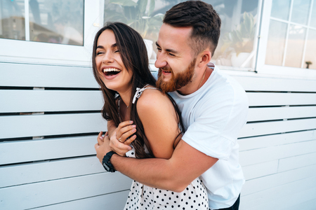 Handsome bearded man hugging his beautiful girlの写真素材