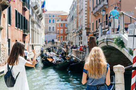 Two young girls stand on the gondola serviceの写真素材