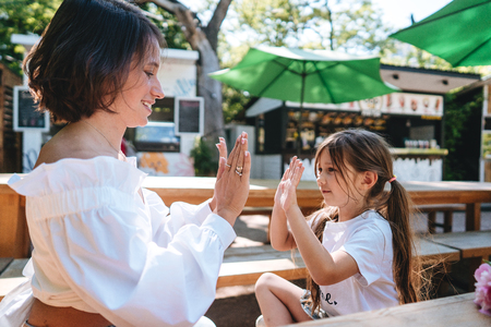 Mother and daughter are sitting in a cafeの写真素材