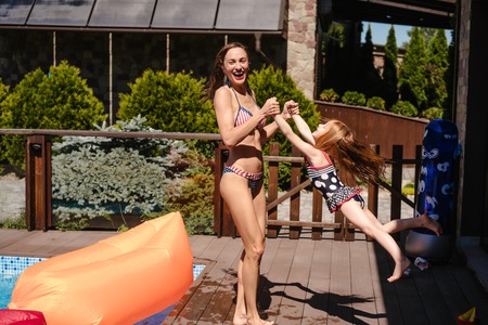 Mom twist her daughter and have funの写真素材