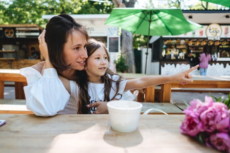 Mother and daughter are sitting in a cafeの写真素材