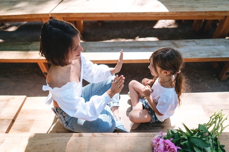 Mother and daughter are sitting in a cafeの写真素材