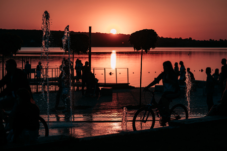 people spend leisure time on the river bankの写真素材