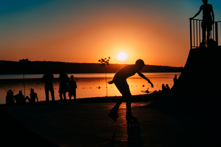 people are resting on a sports field by the river bankの写真素材