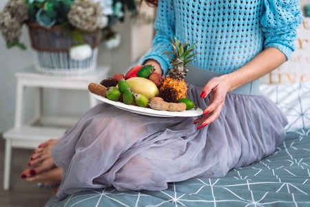 Fruit on a plate in the hands