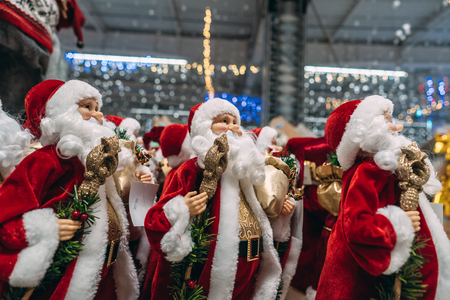 Several small toy Santa Clauses stand in a groupの写真素材
