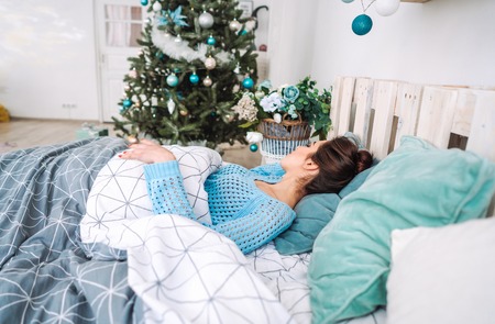 Young woman resting, sleeping in bed